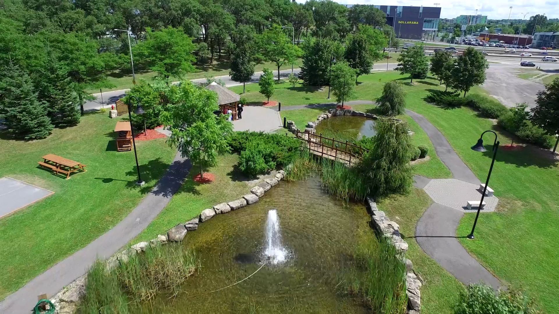 A Fountain Placed on a Stone Railing in a Park