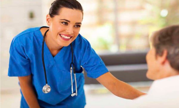 A woman wearing a blue uniform with a stethoscope